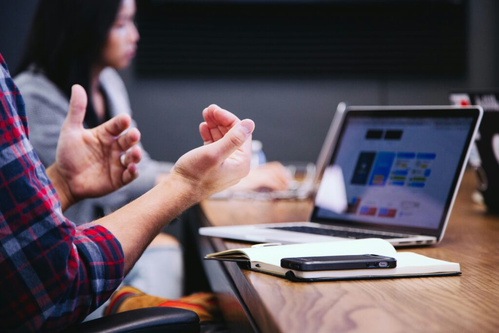 Expressive hands with computer in background